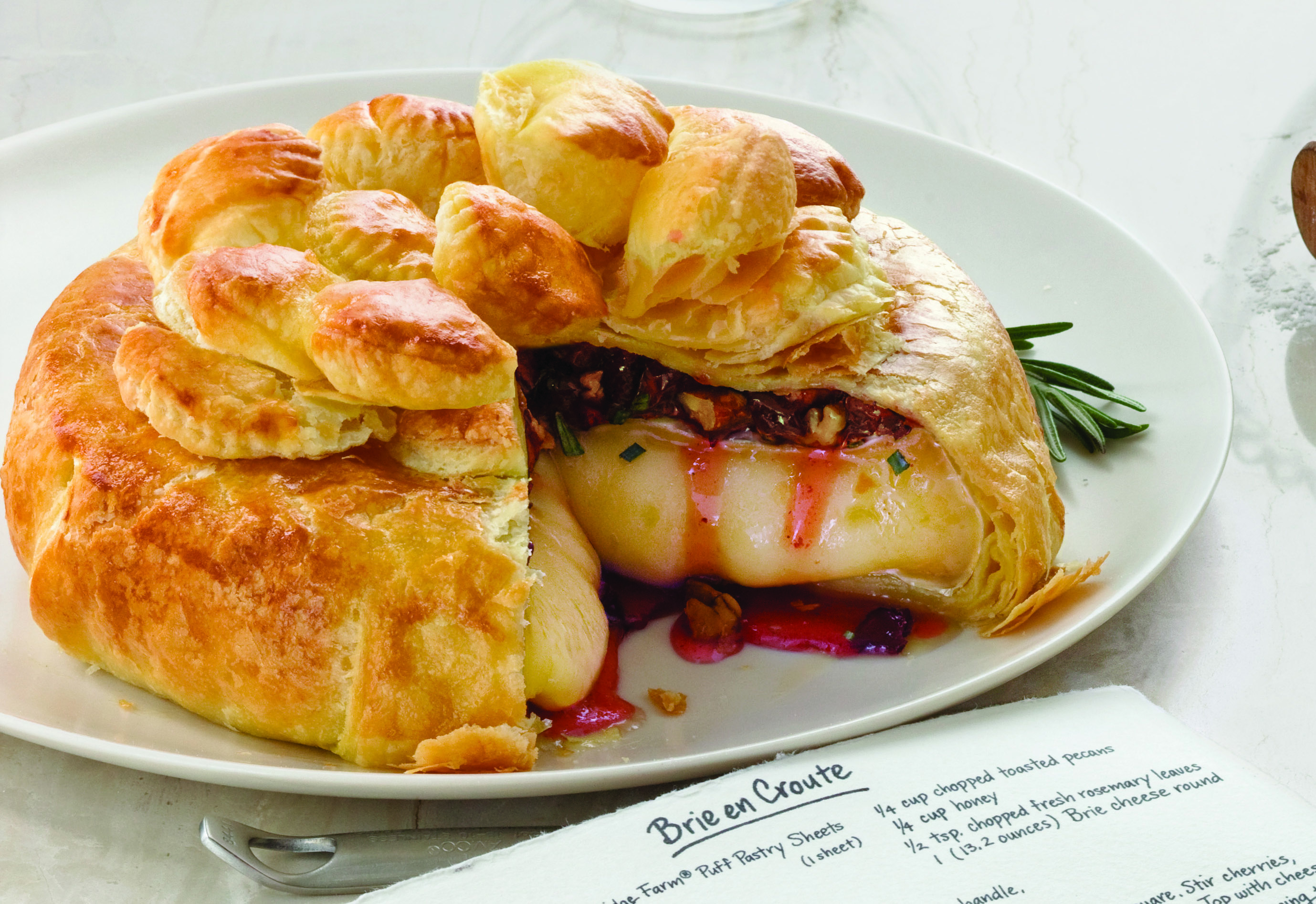 Baked Brie en Croûte with Honey, Dried Cherries, Rosemary & Pecans